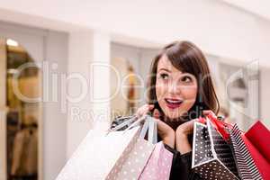 Excited woman holding shopping bags