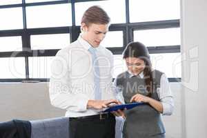 Businessman and businesswoman using digital tablet