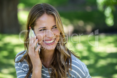 Smiling woman making a phone call