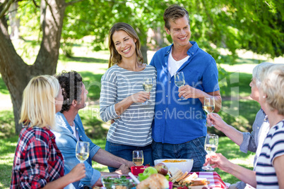 Friends having a picnic with wine