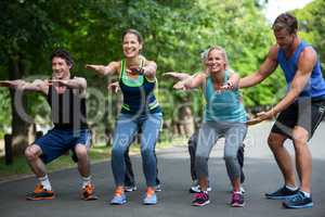 Fitness class doing squat sequence