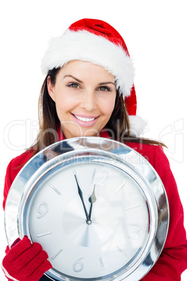 Beautiful brunette with santa hat holding a clock