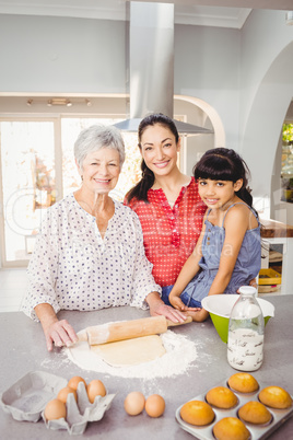 Senior woman smiling while preparing food with family