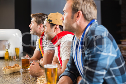 Men watching a game on tv