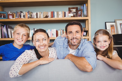 Portrait of smiling family at sofa