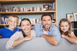 Portrait of smiling family at sofa