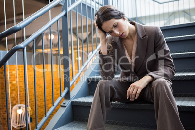 Young businesswoman sitting on staircase