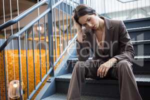 Young businesswoman sitting on staircase