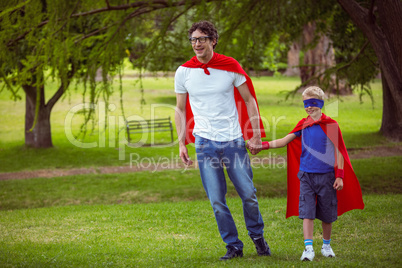 Father and son pretending to be superhero