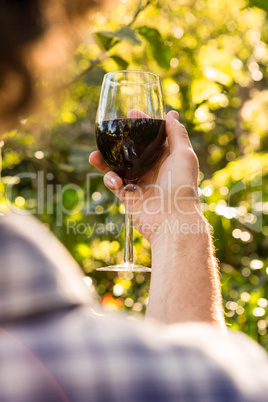 Man holding a glass of red wine