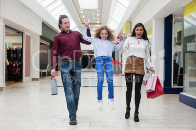 Happy family walking with shopping bags