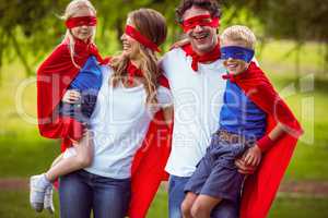 Happy family pretending to be superhero