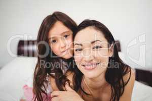 Portrait of happy mother and daughter at home