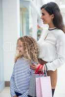 Happy mother and daughter in shopping mall