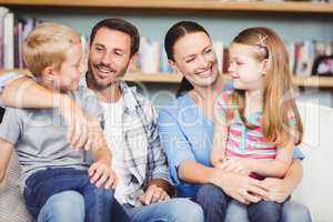 Happy family sitting on sofa at home