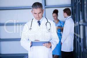 Male doctor looking at digital tablet in hospital