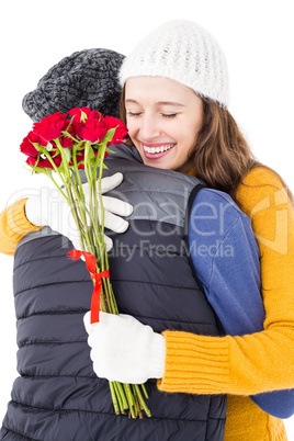 Happy couple hugging each other with flowers