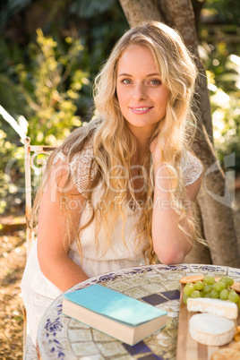 Beautiful blonde relaxing with a book and food