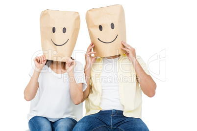 Couple covering their faces with paper bag