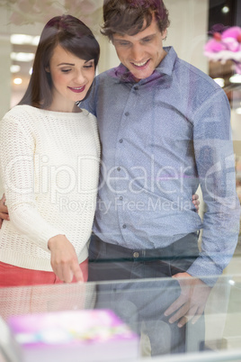 Happy couple shopping in mall