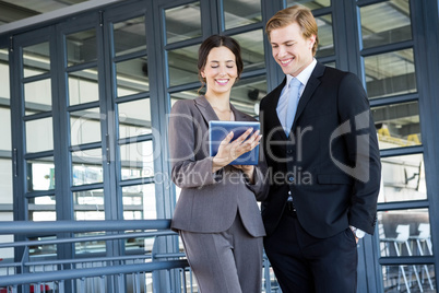 Businessman and businesswoman discussing in office