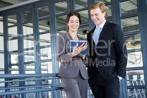 Businessman and businesswoman discussing in office