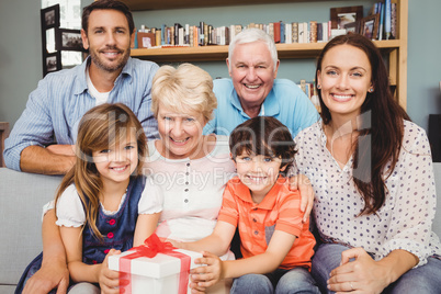 Portrait of happy family with gift box