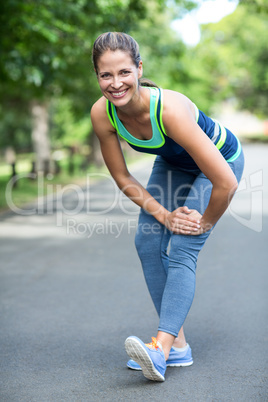 Sportswoman stretching her legs
