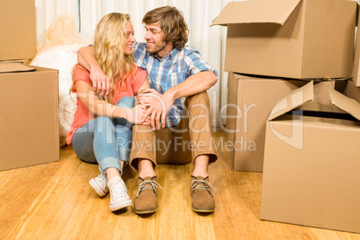 Happy couple sitting on the floor