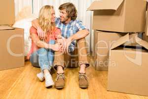 Happy couple sitting on the floor