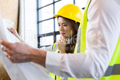 Architects looking at blueprint