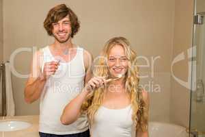 Cute couple brushing their teeth together