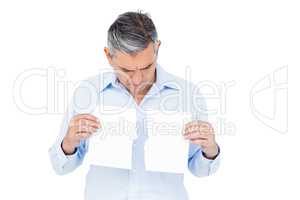 Man holding torn white paper