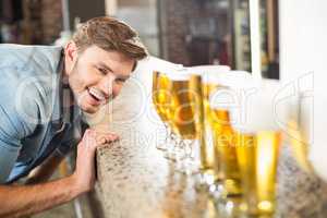 Man looking down lined up beers