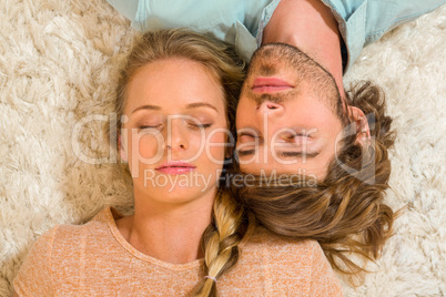 Cute couple sleeping on the carpet