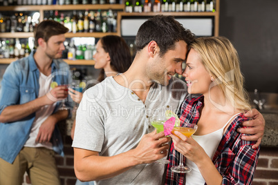 Couple toasts with cocktails