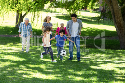 Smiling family playing football