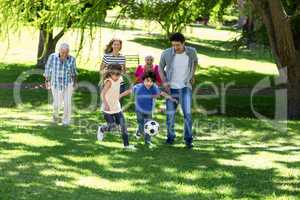 Smiling family playing football