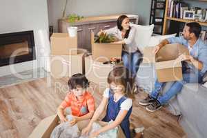 High angle view of family unpacking cardboard boxes