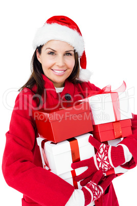 Beautiful brunette with santa hat holding christmas gifts