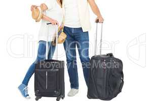 Happy couple in vacation with luggage