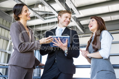 Three colleagues discussing in office