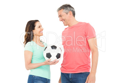 Excited football fan couple cheering at camera