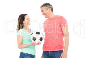 Excited football fan couple cheering at camera