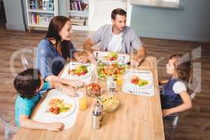 Family discussing with food on dining table