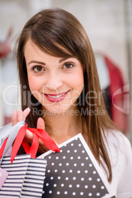 Portrait of woman holding shopping bags