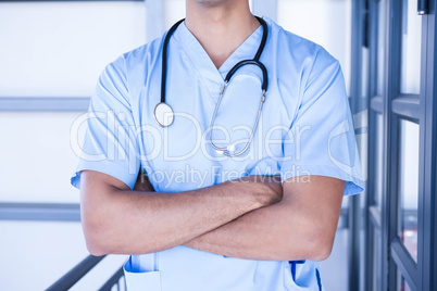 Male doctor standing with arms crossed Male doctor standing with arms crossed