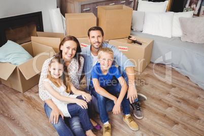 High angle portrait of family with cardboard boxes
