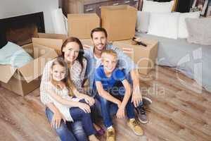 High angle portrait of family with cardboard boxes