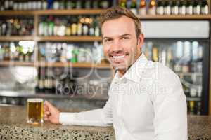 Handsome man holding a beer